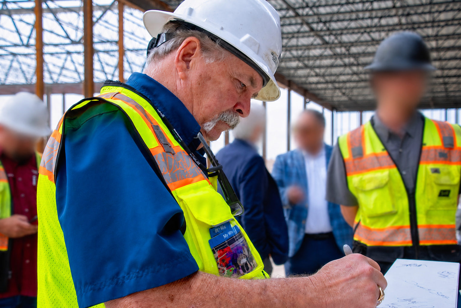 Clyde Pershall reviewing field documents on an active construction site